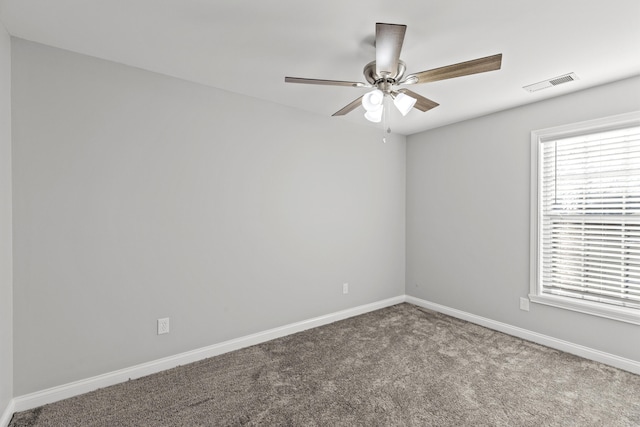 carpeted empty room featuring ceiling fan