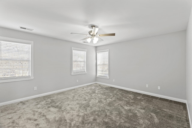 carpeted empty room featuring ceiling fan