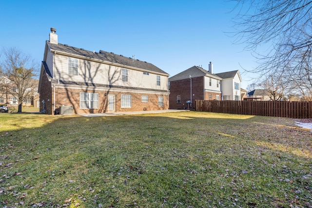 back of house featuring a yard