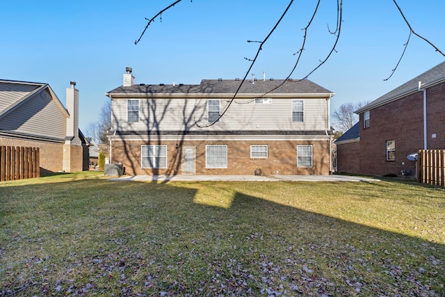 rear view of property featuring a patio area and a lawn