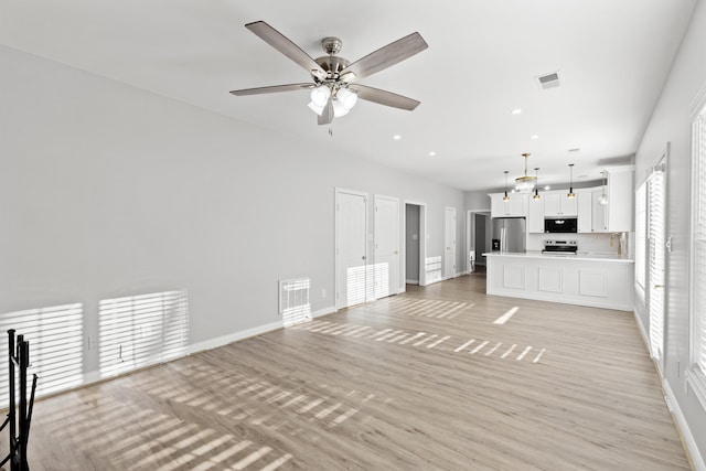 unfurnished living room with ceiling fan and light hardwood / wood-style flooring