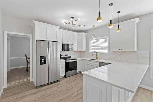 kitchen with appliances with stainless steel finishes, sink, and white cabinets