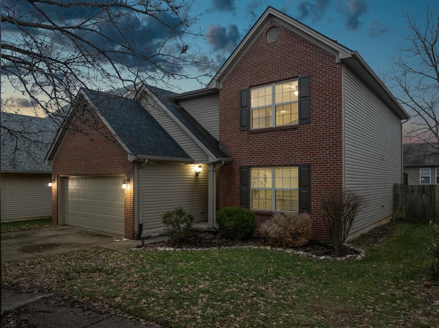 view of property featuring a garage and a yard