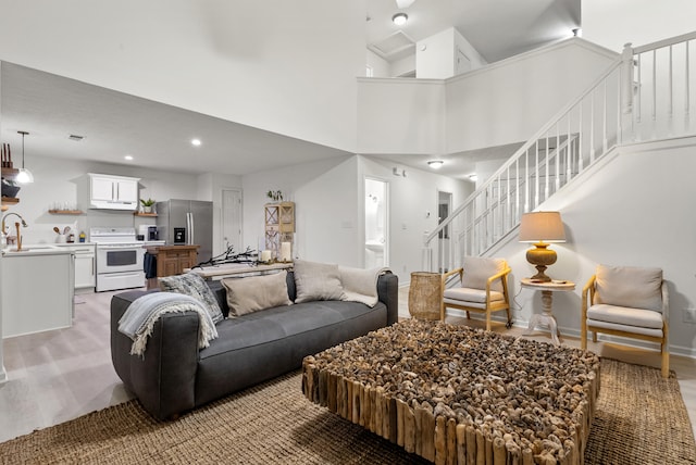 living room featuring a high ceiling and sink