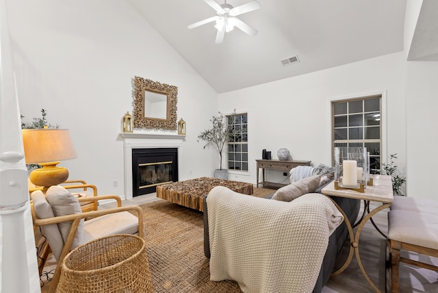 living room with ceiling fan and high vaulted ceiling