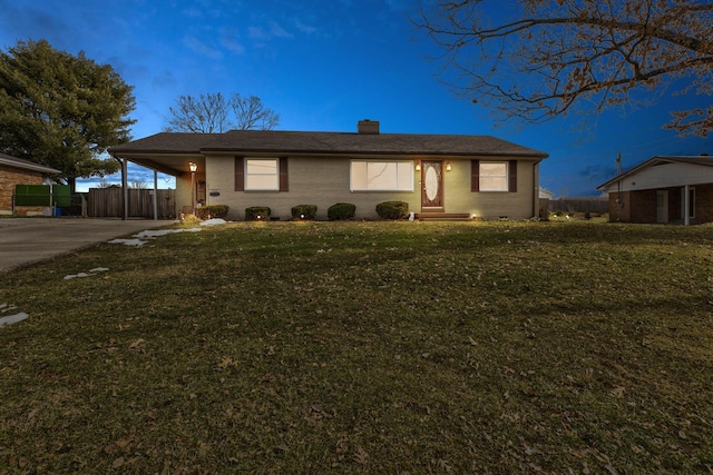 ranch-style house with a carport and a yard