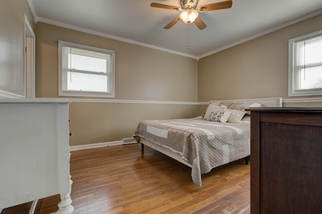 bedroom featuring wood-type flooring, ornamental molding, and ceiling fan