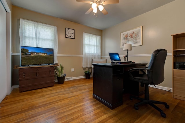 home office featuring ceiling fan and light hardwood / wood-style floors