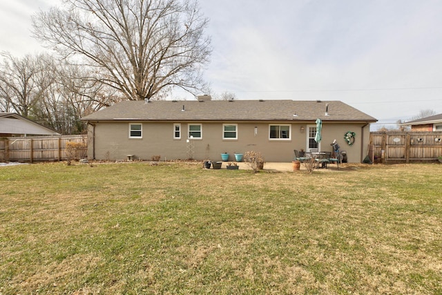 back of property featuring a patio area and a lawn