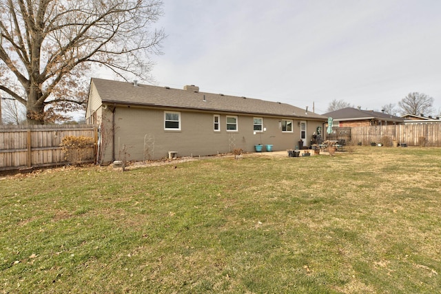 back of house with a yard