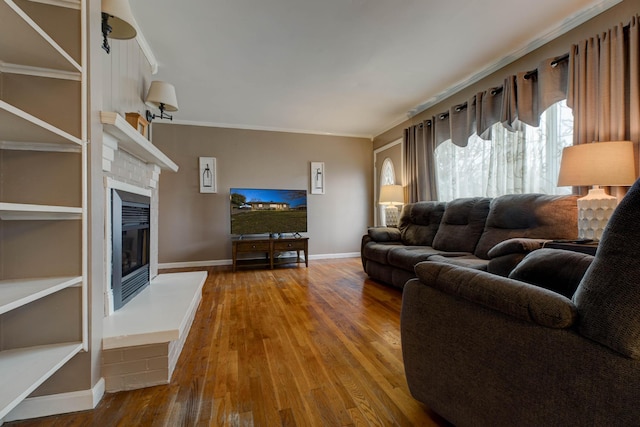 living room with crown molding and hardwood / wood-style floors
