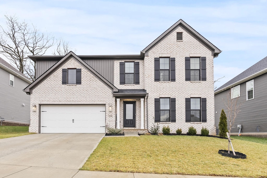 view of front of house featuring a garage and a front lawn