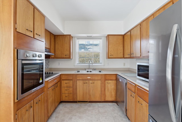 1952-1954 Fontaine Rd, Lexington, KY 40502 - kitchen with light countertops, stainless steel appliances, under cabinet range hood, a sink, and light tile patterned floors