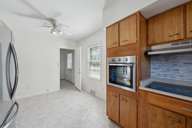 1952-1954 Fontaine Rd, Lexington, KY 40502 - kitchen featuring backsplash, appliances with stainless steel finishes, brown cabinetry, under cabinet range hood, and visible vents