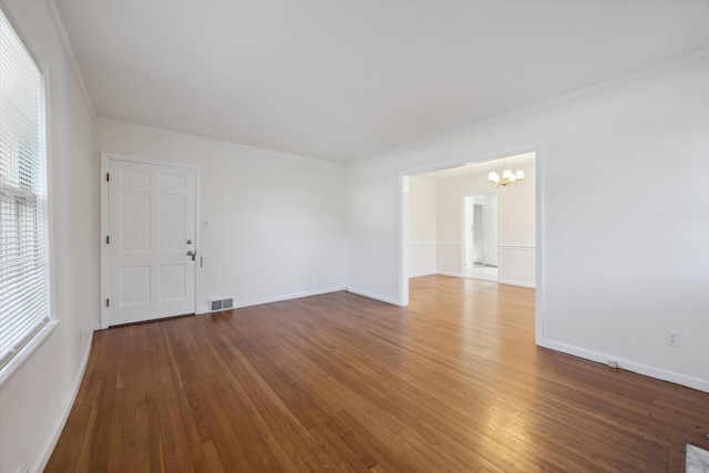 1952-1954 Fontaine Rd, Lexington, KY 40502 - empty room with baseboards, visible vents, hardwood / wood-style flooring, and an inviting chandelier