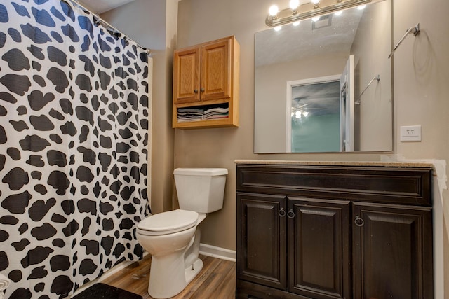 bathroom featuring vanity, hardwood / wood-style flooring, and toilet