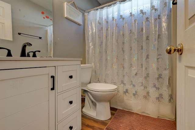 full bathroom with shower / bathtub combination with curtain, vanity, toilet, and hardwood / wood-style floors