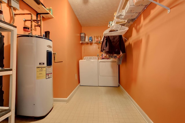 washroom featuring independent washer and dryer, water heater, and a textured ceiling