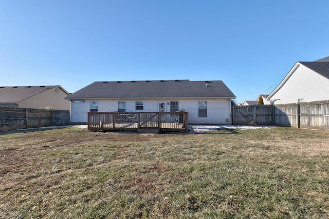 rear view of house featuring a yard and a deck