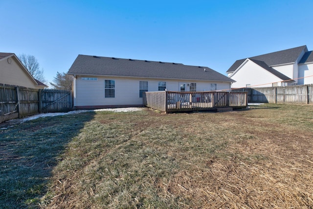 back of house with a wooden deck and a yard