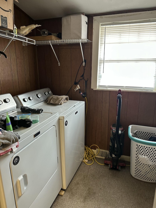 washroom featuring separate washer and dryer and wooden walls