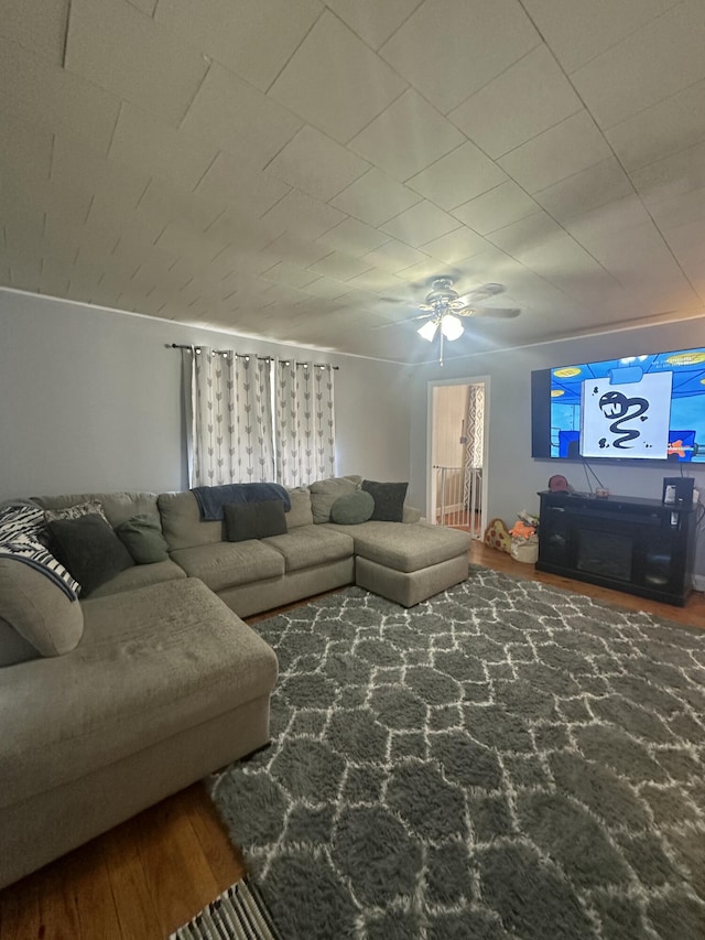 living area with ceiling fan and wood finished floors