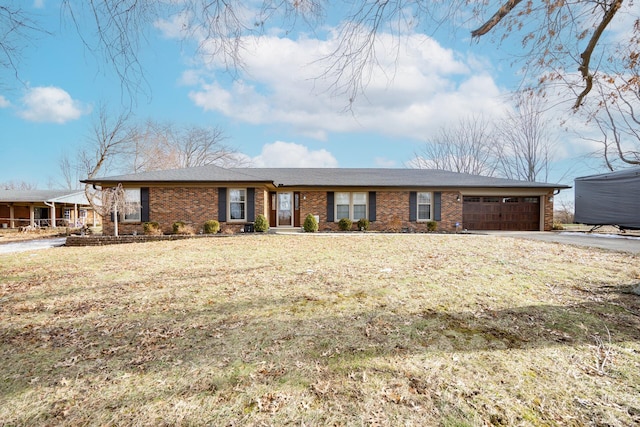 ranch-style house featuring a garage and a front yard