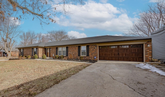 single story home featuring a garage and a front yard