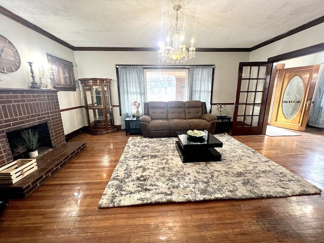 living room with a textured ceiling, a fireplace, and hardwood / wood-style flooring