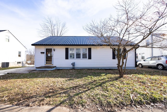 ranch-style house featuring central AC and a front yard