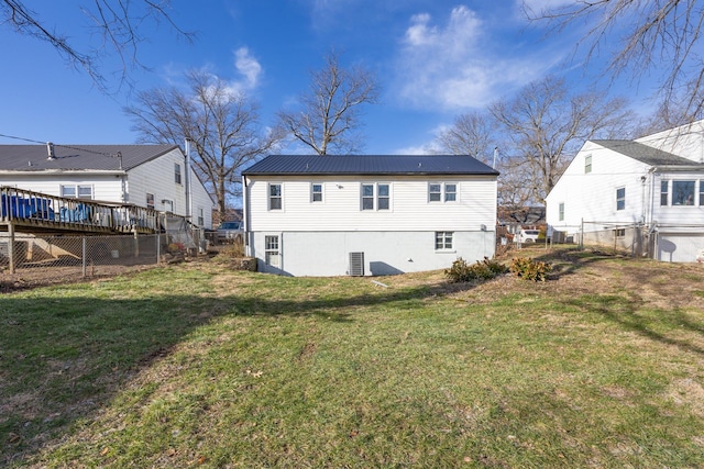 rear view of house featuring a yard