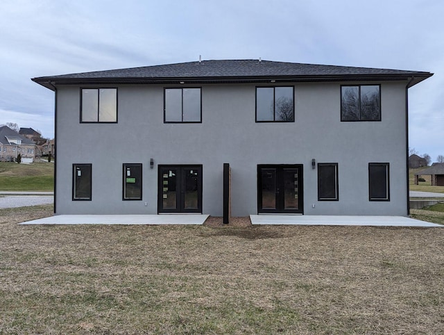 back of house featuring a patio, a yard, and french doors