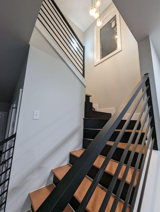 stairway featuring a high ceiling