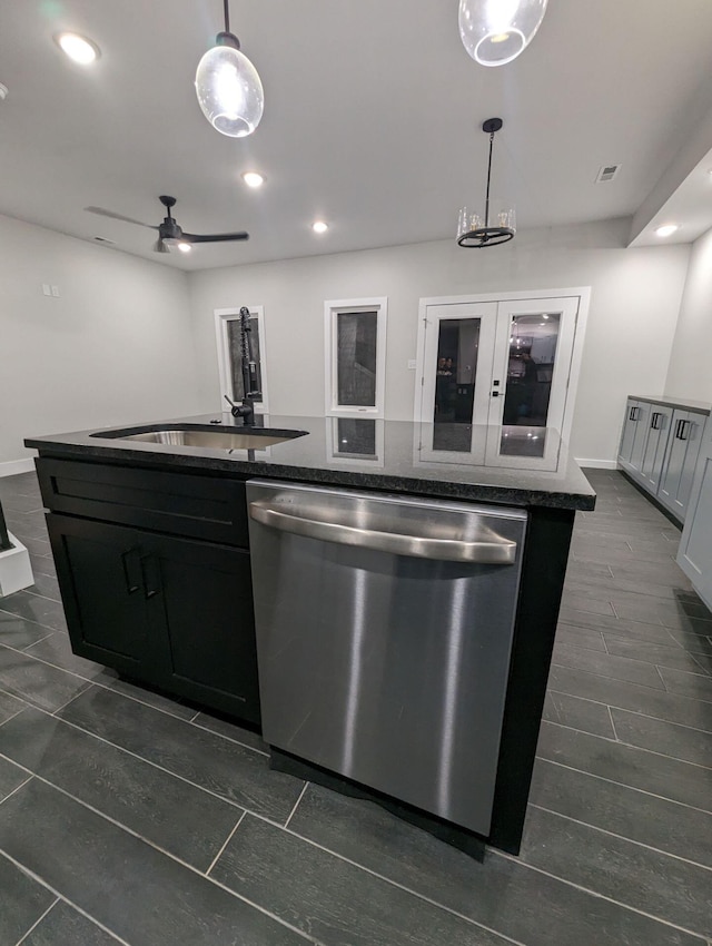 kitchen with sink, ceiling fan, dishwasher, a center island with sink, and decorative light fixtures