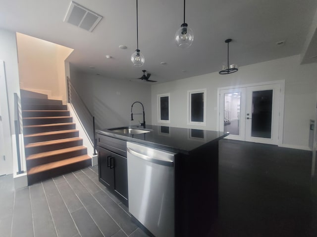 kitchen with pendant lighting, sink, dishwasher, hardwood / wood-style floors, and a center island with sink