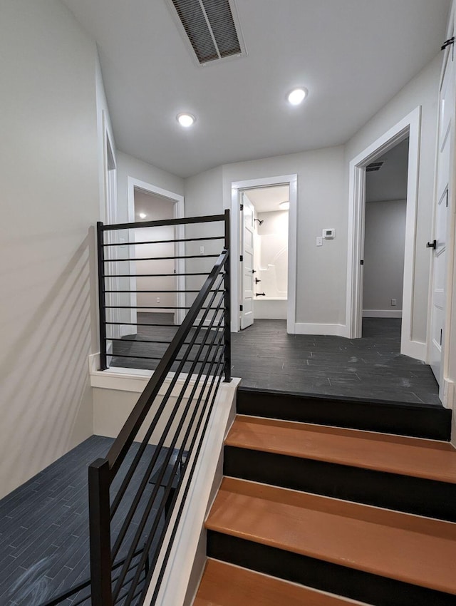 staircase with hardwood / wood-style flooring