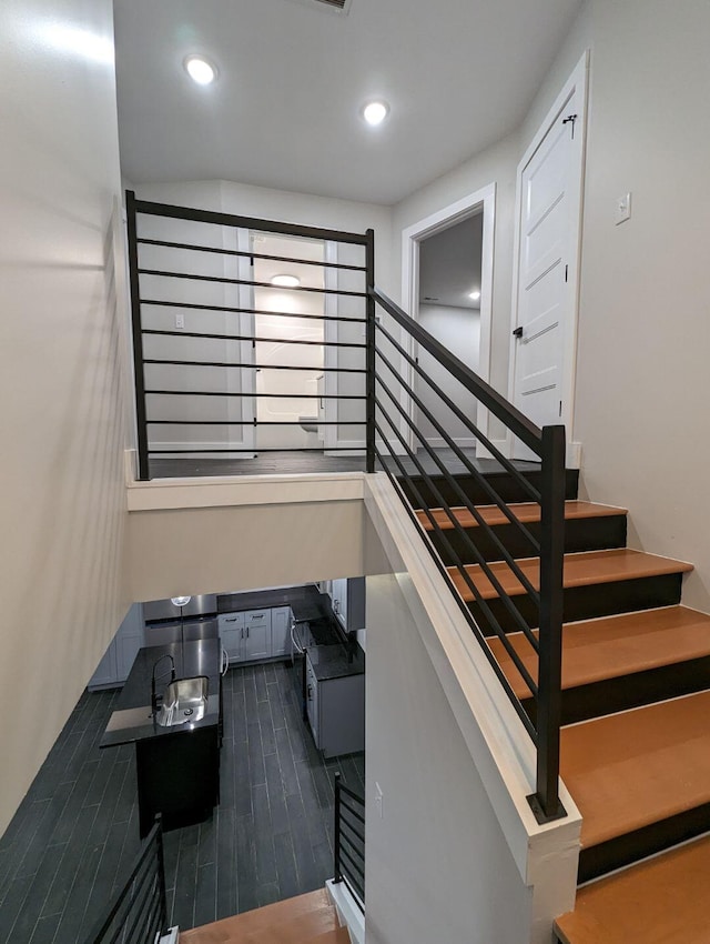 stairs featuring wood-type flooring