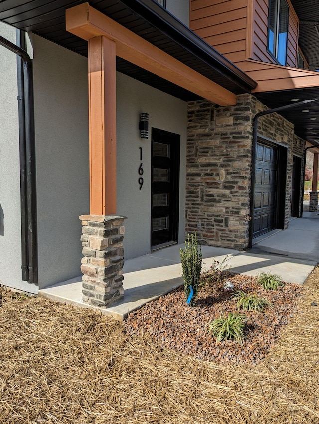 doorway to property with a garage