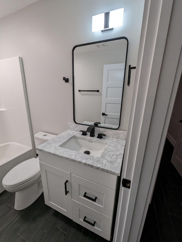 bathroom featuring vanity and toilet