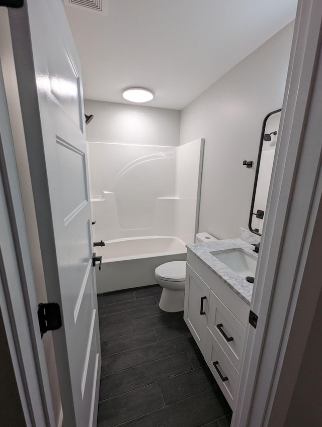 full bathroom featuring vanity, shower / bathing tub combination, and toilet