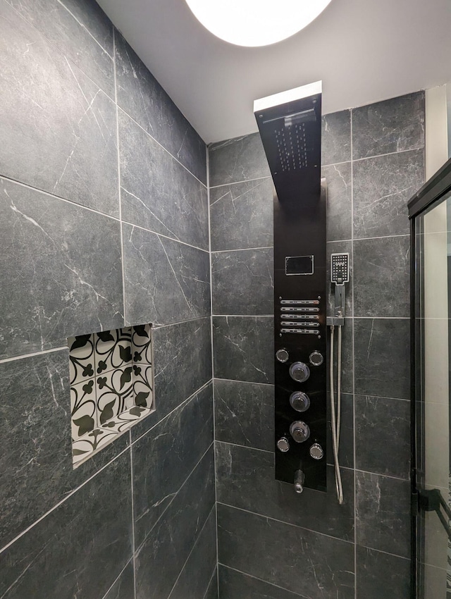 bathroom with a tile shower