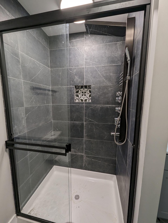 bathroom featuring a shower with door