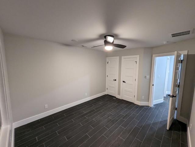 unfurnished bedroom with dark wood-type flooring and ceiling fan