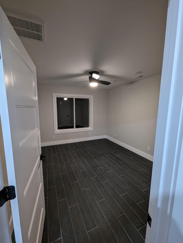 spare room featuring ceiling fan and dark hardwood / wood-style flooring