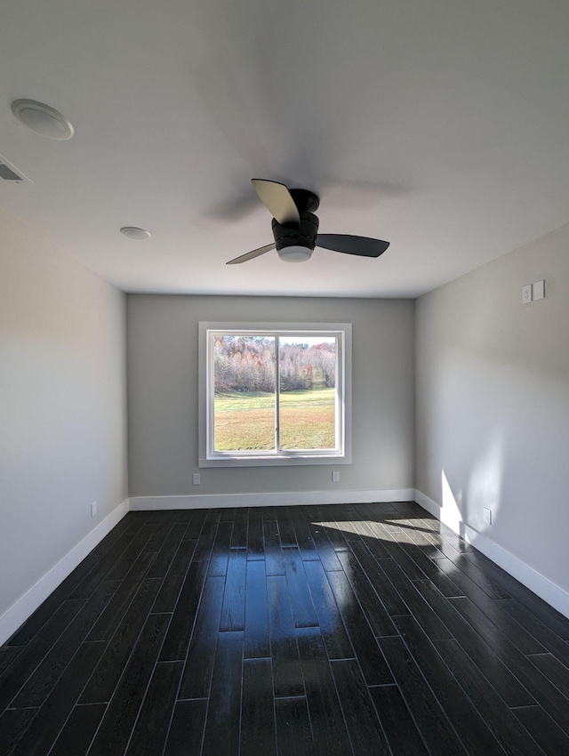 spare room with dark hardwood / wood-style floors and ceiling fan