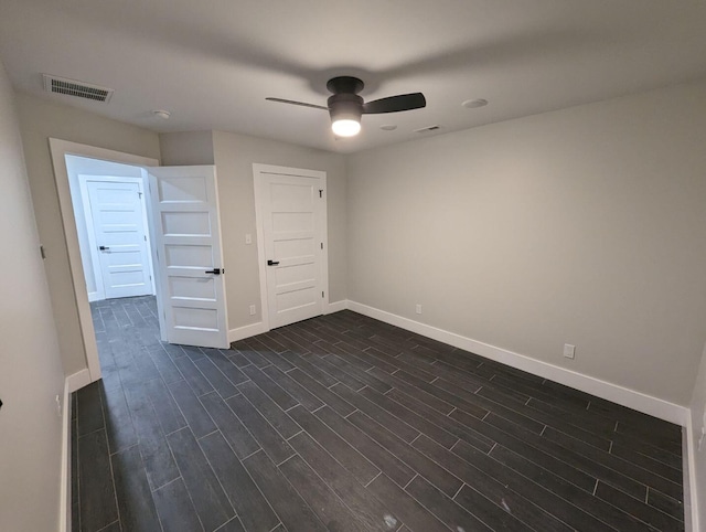 unfurnished bedroom with dark wood-type flooring and ceiling fan