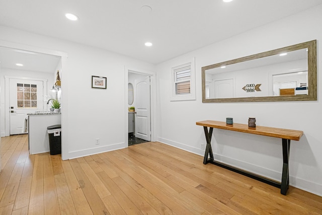 hallway with light hardwood / wood-style flooring