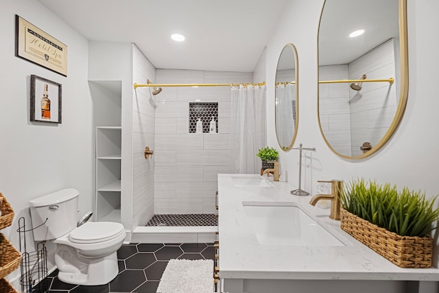 bathroom featuring vanity, a shower with shower curtain, tile patterned floors, and toilet