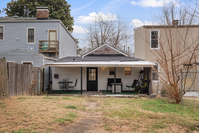 rear view of property with a lawn
