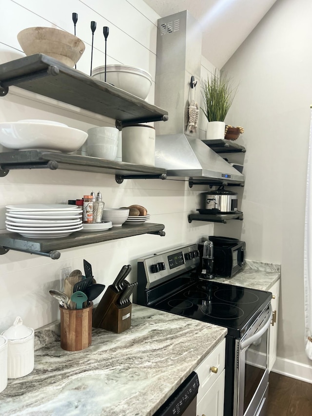 kitchen featuring light stone counters, appliances with stainless steel finishes, dark hardwood / wood-style flooring, and white cabinets